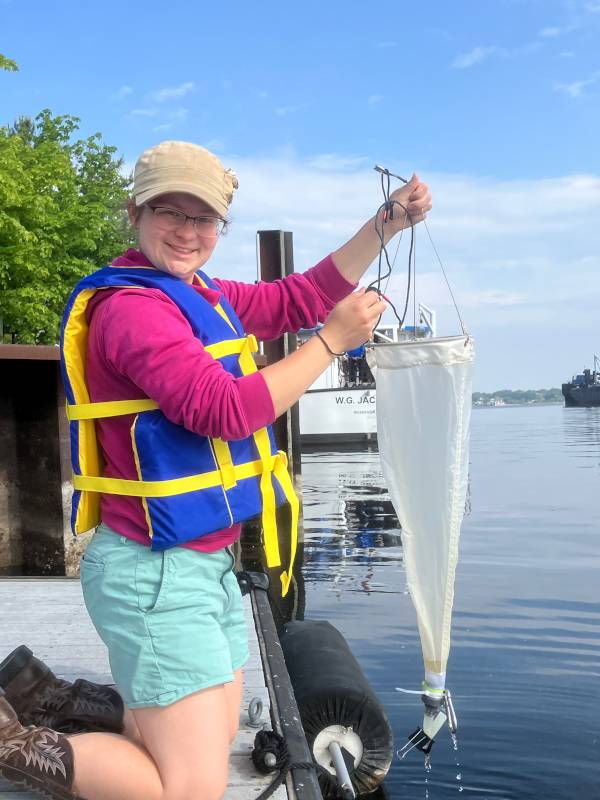 Bridget Rozema holds a plankton net dockside
